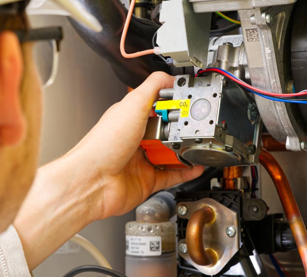 professional repairing a gas boiler